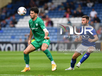 Nathan Sheron of Oldham Athletic tussles with Joe Quigley of Chesterfield Football Club during the Vanarama National League match between Ol...