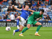 Nathhan Sheron of Oldham Athletic tussles with Joe Quigley of Chesterfield Football Club during the Vanarama National League match between O...
