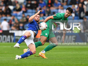 Nathan Sheron of Oldham Athletic tussles with Joe Quigley of Chesterfield Football Club during the Vanarama National League match between Ol...