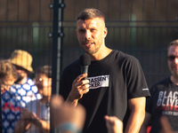 Lukas Podolski, a german football player, speaks to the youth during his opening of his new soccer training field for youth in Buchforst in...