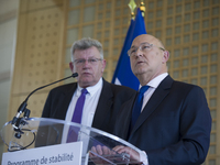French Finance Minister Michel Sapin (R) and Budget Junior Minister Christian Eckert attend a press conference to present the French governm...