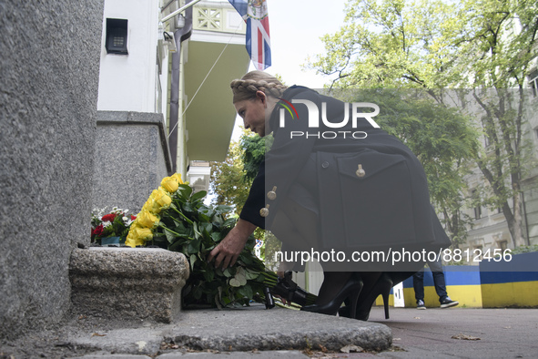 Former Ukrainian Prime Minister Yulia Tymoshenko lays flowers to mourn the death of Queen Elizabeth outside the British Embassy, amid Russia...