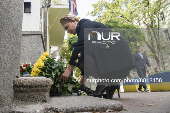 Former Ukrainian Prime Minister Yulia Tymoshenko lays flowers to mourn the death of Queen Elizabeth outside the British Embassy, amid Russia...