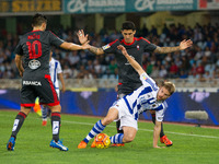Illarramendi (R) of Real Sociedad duels for the ball with Pablo Hernandez (C) and Nolito (L) of Celta de Vigo during the Spanish league foot...