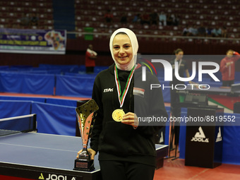 Dina Meshref poses for photos after winning the women's final match between Dina Meshref of Egypt and Yousra Helmy of Egypt at the 2022 ITTF...