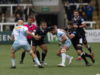 Nick David of Harlequins is tackled by George McGuigan Of Newcastle Falcons and Greg Peterson Of Newcastle Falcons during the Gallagher Prem...