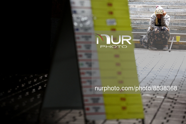 People walk past the empty exchange rates plates in Kyiv, Ukraine, August 5, 2022. The National Bank of Ukraine has banned non-banking insti...