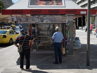 Two men are looking newspapers on a kiosk in the center of Athens, Greece on September 14, 2022. (