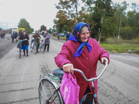 Peasant women walk in the center of Verbivka village, a few kilometers from Balakliya, Kharkiv region, on September 13, 2022.. (
