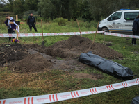 The body of a man shot on September 7 by the Russian military lies on the ground after the exhumation procedure, Balakliya, Kharkiv region,...