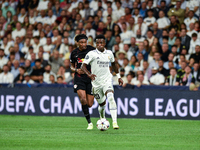 Vinicius Junior and Mohamed Simakan during UEFA Champions League match between Real Madrid and RB Leipzig at Estadio Santiago Bernabeu on Se...
