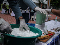The Indonesian Navy is seen destroying evidence of methamphetamine weighing 23.98 Kilograms using a blender after being mixed with water and...