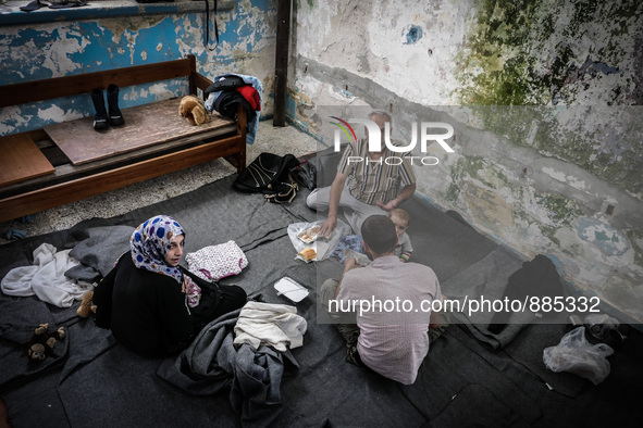 People eat in Leros Refugee Camp, Greece, on October 30, 2015. Refugee camp Leros, located on the Greek Island of Leros is a transit camp fo...