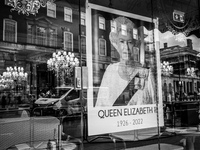 (EDITOR’S NOTE: Image was converted to black and white) A poster of Queen Elizabeth II near the Palace of Westminster on September 15, 2022...