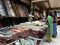 Customers look at cloth to be made into ladies churidar suits at a textile shop in Thiruvananthapuram, Kerala, India, on May 22, 2022. (