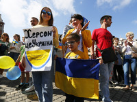 Kherson residents hold placards during a rally timed to the Day of the city in the center of Odesa, Ukraine 17 September 2022. Residents of...