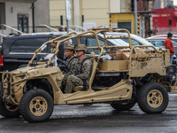 US Marines corps soldiers driving the buggy style military vehicles to the Wasp-class amphibious assault ship of the United States Navy USS...