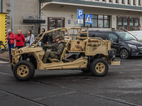 US Marines corps soldiers driving the buggy style military vehicles to the Wasp-class amphibious assault ship of the United States Navy USS...