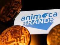 Animoca Brands logo displayed on a phone screen and representation of cryptocurrencies are seen in this illustration photo taken in Krakow,...