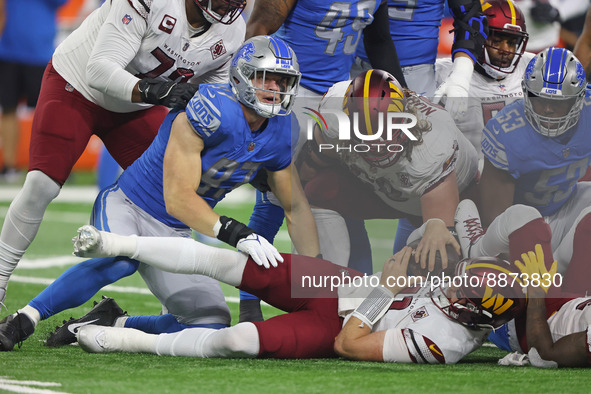 Washington Commanders quarterback Carson Wentz (11) is sacked by Detroit Lions defensive end Aidan Hutchinson (97) during the first half of...