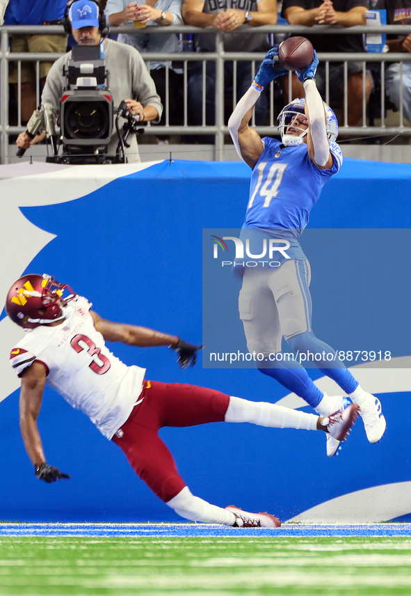 Wide receiver Amon-Ra St. Brown (14) of the Detroit Lions catches the ball for a touchdown during an NFL football game between the Detroit L...