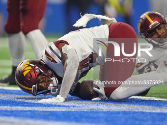 Washington Commanders running back Antonio Gibson (24) scores a touchdown during the second half of an NFL football game against the Detroit...