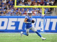 Detroit Lions wide receiver Amon-Ra St. Brown (14) runs the ball during the second half of an NFL football game against the Washington Comma...