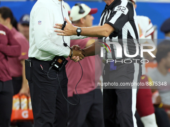 Head coach Ron Rivera of the Washington Commanders talks with referee Bill Vinovich (52) during an NFL football game between the Detroit Lio...