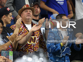 A Washington Commanders fan and a Detroit Lions fan  cheer during the second half of an NFL football game between the Washington Commanders...