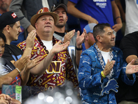 A Washington Commanders fan and a Detroit Lions fan  cheer during the second half of an NFL football game between the Washington Commanders...