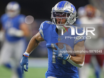 Detroit Lions wide receiver Amon-Ra St. Brown (14) runs the ball during the first half of an NFL football game against the Washington Comman...