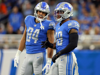 Tight end Shane Zylstra (84) of the Detroit Lions talks with linebacker Chris Board (49) of the Detroit Lions between plays during an NFL fo...