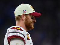 Quarterback Carson Wentz (11) of the Washington Commanders waits on the sidelines during an NFL football game between the Detroit Lions and...