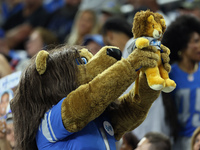 Detroit Lions mascot Roary lifts up a cub during the Lions Cub Cam during an NFL football game between the Detroit Lions and the Washington...