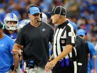 Head coach Dan Campbell of the Detroit Lions talks with line judge Mark Perlman (9) during an NFL football game between the Detroit Lions an...
