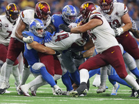 Washington Commanders running back Antonio Gibson (24) is tackled by Detroit Lions linebacker Malcolm Rodriguez (44) during the second half...