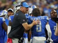 Head coach Dan Campbell of the Detroit Lions congratulates wide receiver Josh Reynolds (8) of the Detroit Lions after a successful play duri...