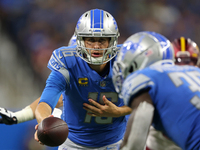Detroit Lions quarterback Jared Goff (16) hands off the ball during the second half of an NFL football game against the Washington Commander...