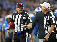 Back judge Jimmy Russell (82) discusses a call with referee Bill Vinovich (52) during an NFL football game between the Detroit Lions and the...