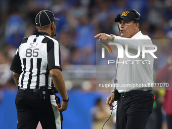 Washington Commanders head coach Ron Rivera talks to side judge Jimmy Buchanan (86) during the first half of an NFL football game against th...
