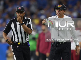 Washington Commanders head coach Ron Rivera talks to side judge Jimmy Buchanan (86) during the first half of an NFL football game against th...