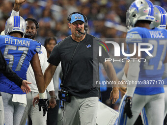 Head coach Dan Campbell of the Detroit Lions congratulates the line coming off the field after a successful play during an NFL football game...