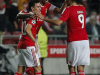 Benfica's defender Luisao (C) celebrates his goal with Benfica's midfielder Nicolas Gaitan (L) and Benfica's forward Raul Jimenez (R)  durin...