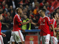 Benfica's defender Luisao (L) celebrates his goal Benfica's forward Jonas (R)  during the Champions League  football match between SL Benfic...