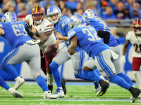 Quarterback Jared Goff (16) of the Detroit Lions hands off the ball to running back D'Andre Swift (32) of the Detroit Lions during an NFL fo...