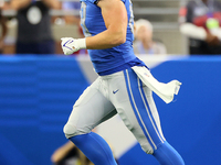 Tight end T.J. Hockenson (88) of the Detroit Lions runs off the field after a play during an NFL football game between the Detroit Lions and...