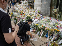On September 19,2022, a man place flower tributes outside of the British Consulate-General Hong Kong as the world reacts to the passing of Q...