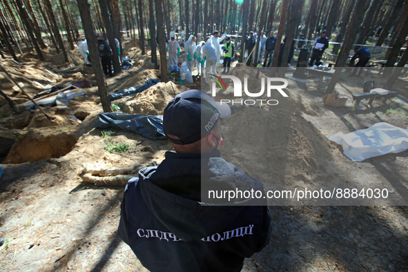 IZIUM, UKRAINE - SEPTEMBER 19, 2022 - A police investigator is pictured during the exhumation of the bodies of Izium residents tortured to d...