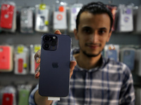A Palestinian man holds Apple's new iPhone 14 at a mobile phone store in Gaza City on September 20, 2022.
 (