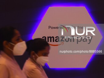 Women walk past a logo of Amazon Pay during Global Fintech Fest in Mumbai, India, 20 September, 2022. (